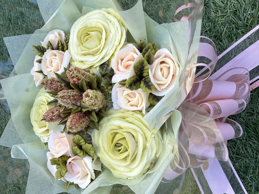 7 Deluxe cupcake bouquet with pistachio green and blush roses wrapped in pastel paper