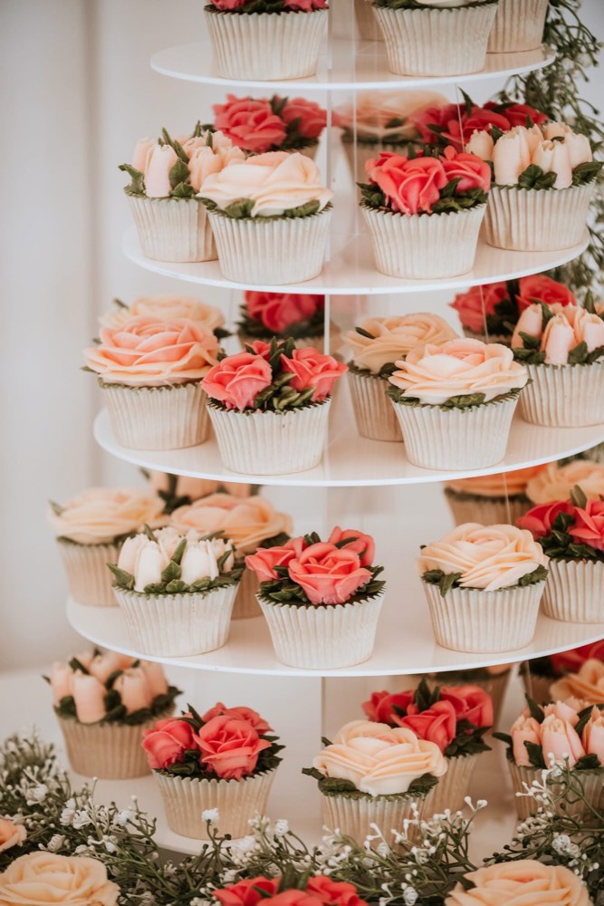 Tiered wedding cupcake tower with coral, peach and ivory buttercream roses