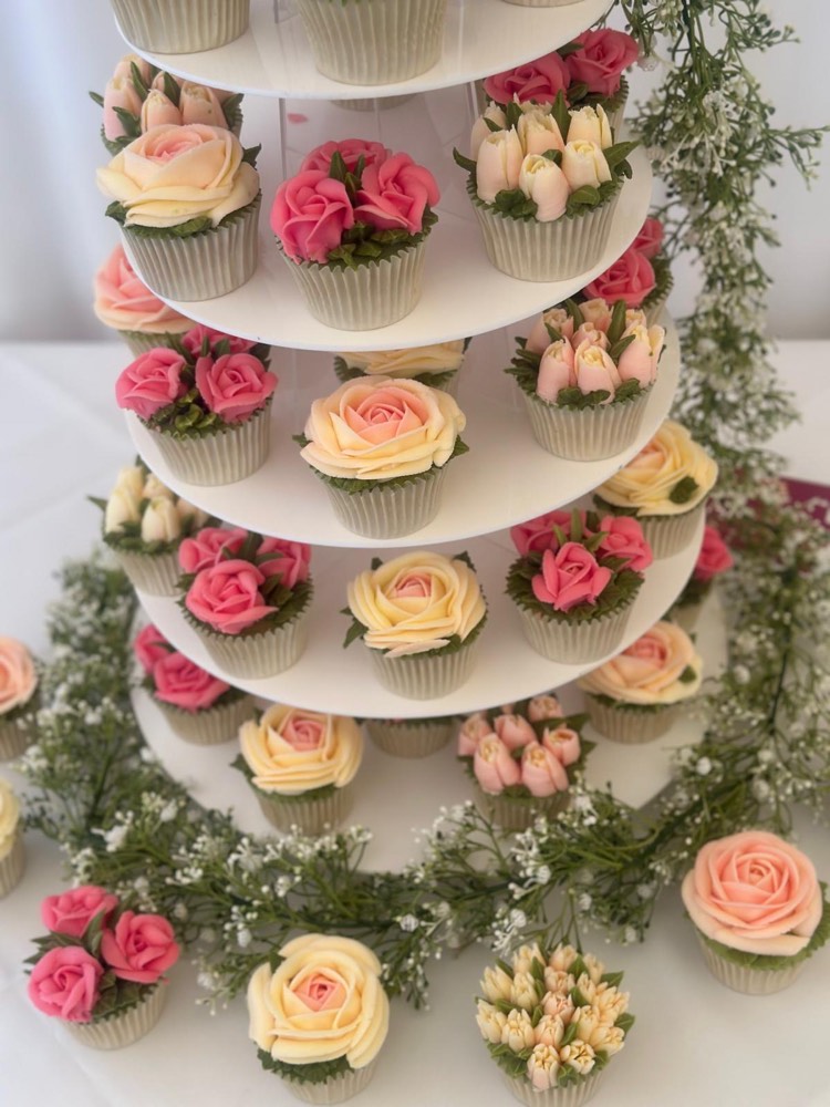 Tiered wedding cupcake tower with coral pink and buttery cream buttercream roses